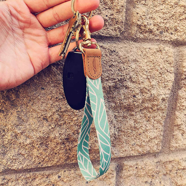 People holding mint cream multicolor leaves hand wrist lanyard with keys on the hand