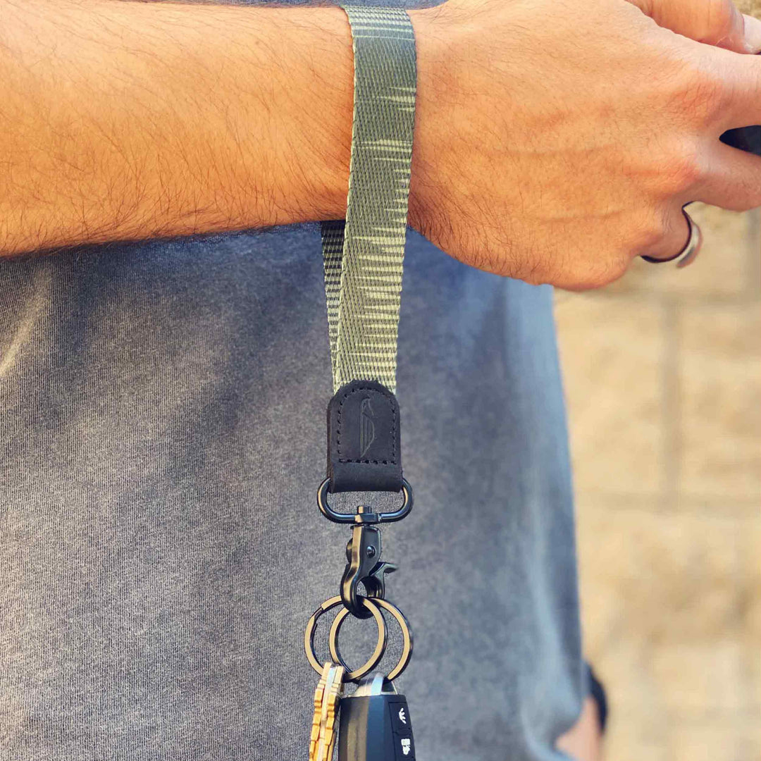 Man wears cool green wrist lanyard to carrying keys