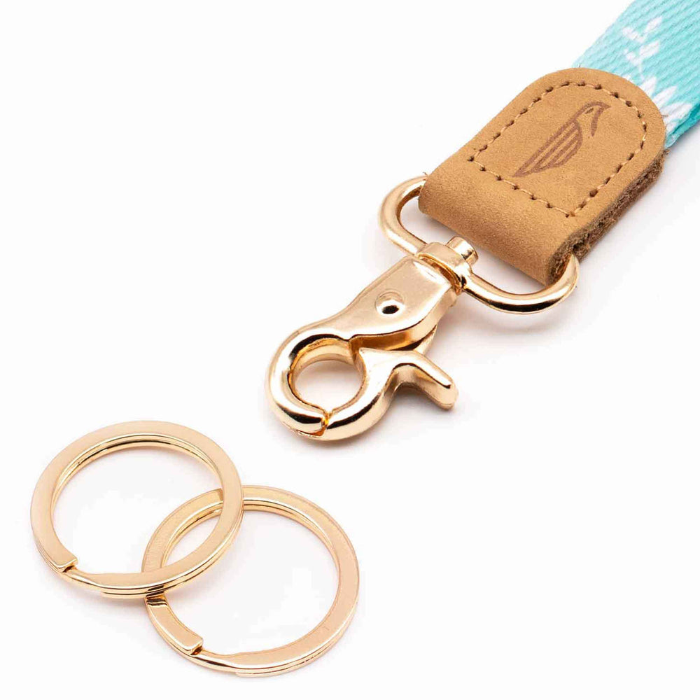 Close up lanyard with 2 gold metal key rings brown leather blue color fabric