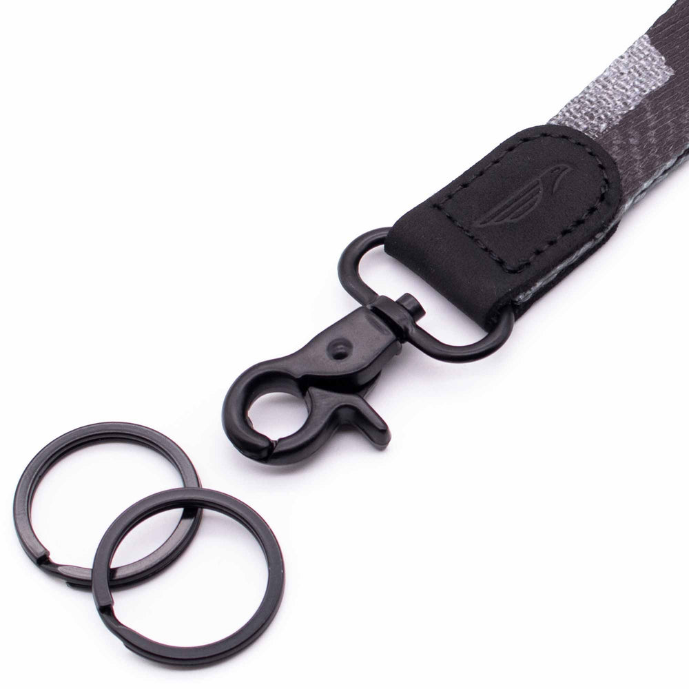 Close up lanyard with 2 black metal key rings black leather gray fabric